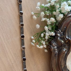 Vintage sterling silver link bracelet featuring faceted smoky quartz gemstones and paved marcasite accents in an Art Deco design.