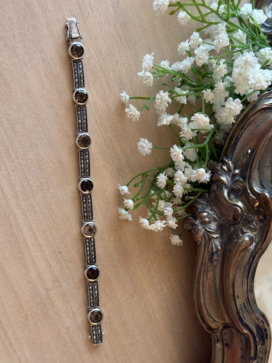 Vintage sterling silver link bracelet featuring faceted smoky quartz gemstones and paved marcasite accents in an Art Deco design.