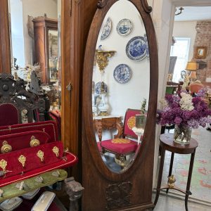 Large antique French style oak cheval floor mirror with a thick bevelled glass, ornate rose basket cresting, and carved lion paw feet.