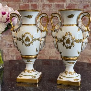 Pair of Limoges porcelain urn vases in French Empire style with swan handles and Napoleonic bees