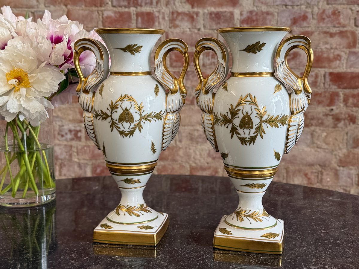 Pair of Limoges porcelain urn vases in French Empire style with swan handles and Napoleonic bees