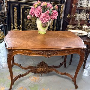 Louis XV style carved walnut table with rocaille apron and cabriole legs