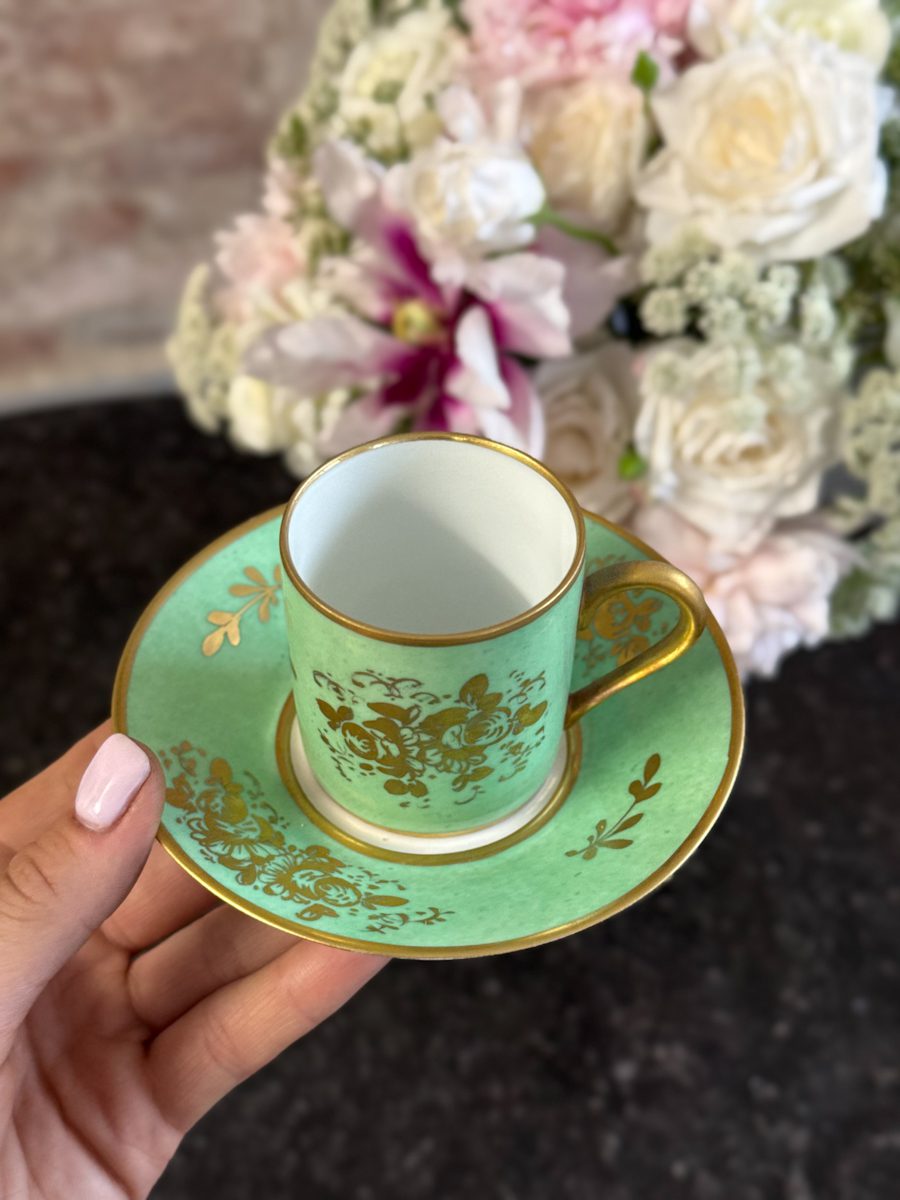 Spectacular antique french porcelain cup and saucer hand-decorated in a radiant empire green glaze with exquisite 24k gold leaf floral gilding, signed "Décoré main".