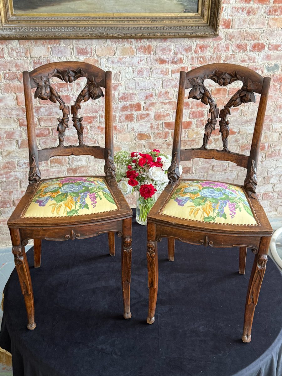 Pair of French Art Nouveau carved oak side chairs with floral upholstery and mascaron legs