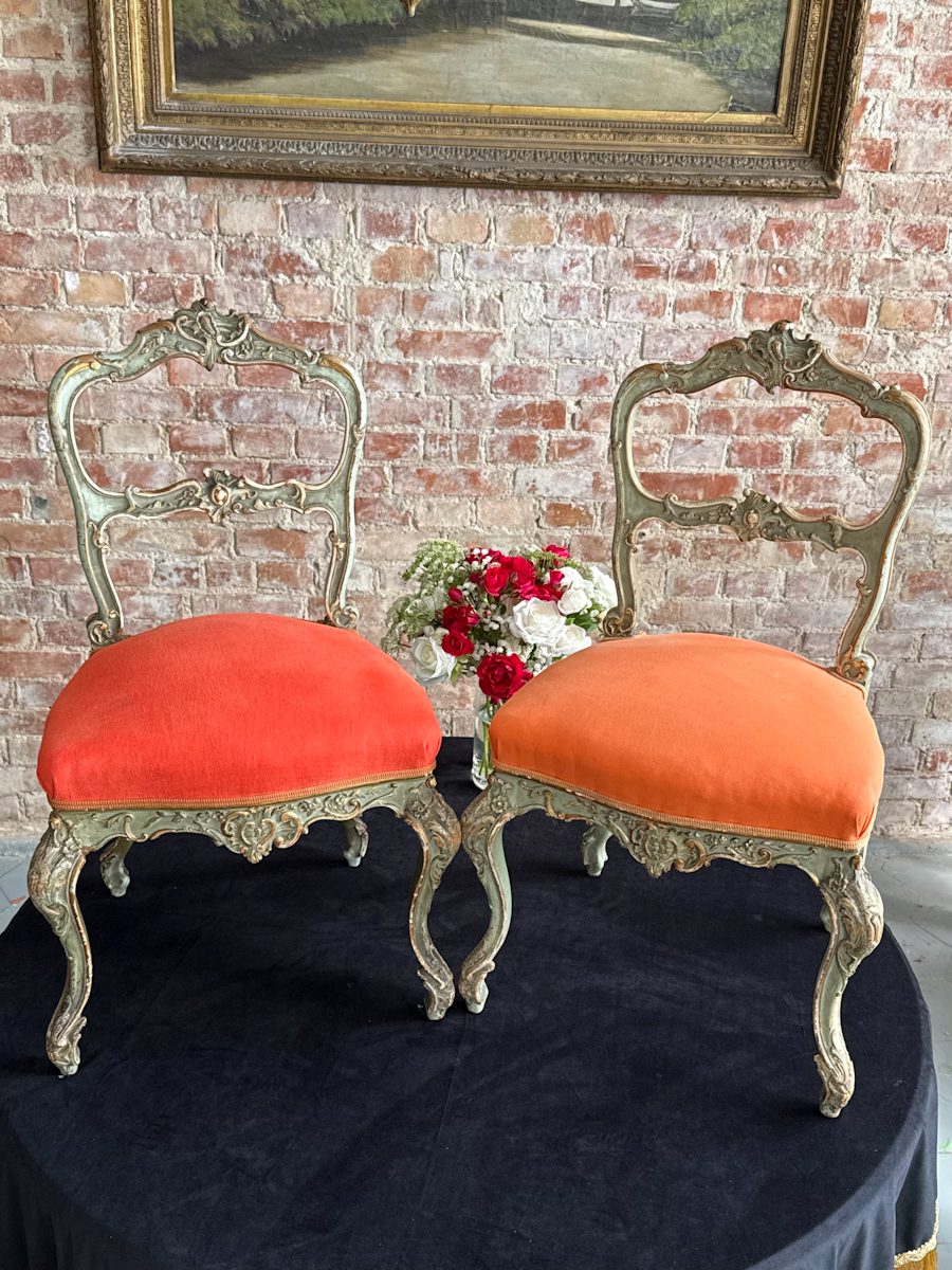 Pair of antique green and gold rococo parlor chairs with orange upholstery